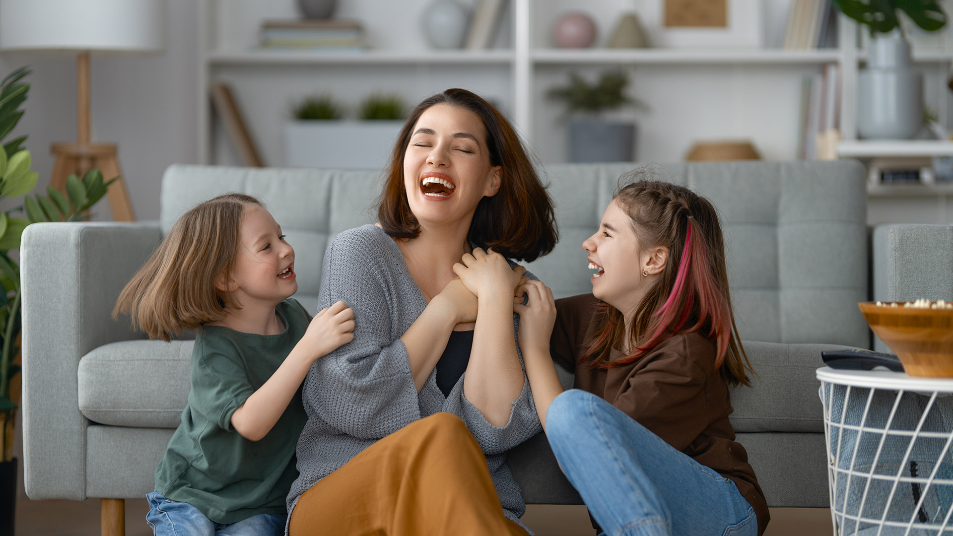 Happy_Family_In_Living_Room_Best1_Plumbing_and_Heating