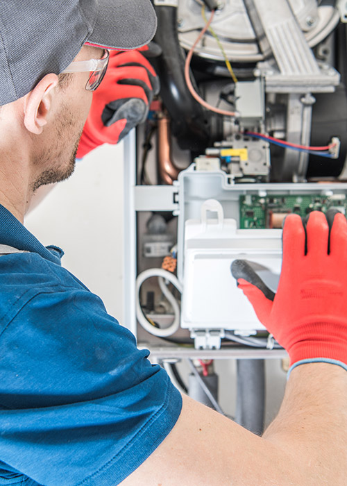 Man_Working_On_Furnace_Bes1_Plumbing_and_Heating