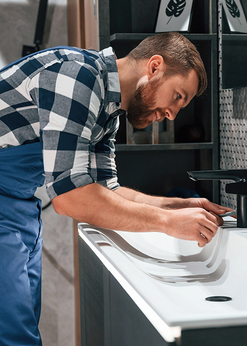 Plumber_Working_On_Bathroom_Sink_Best1_Plumbing_and_Heating